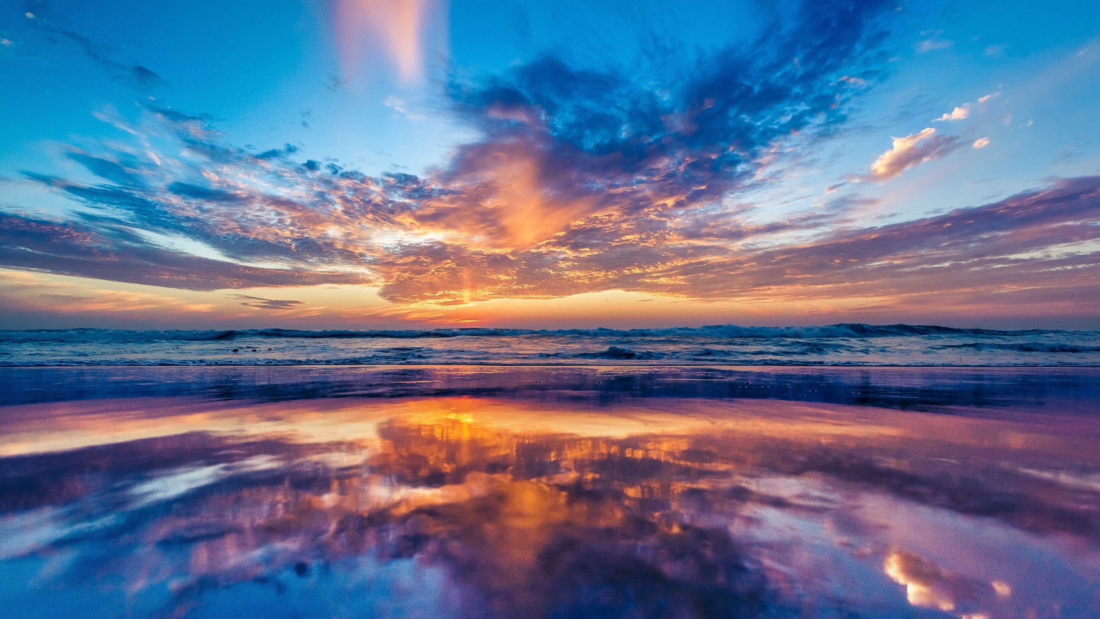 golden sunset skies sandy beach oasis serene ocean views nature's picturesque beauty 4k desktop